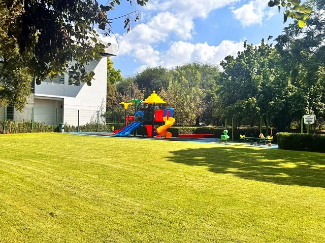 Jardín amplio con juegos infantiles en Club Sportika
